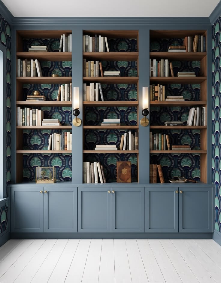 Peacock-blue built-in bookcases with open display shelves and concealed base cabinets.