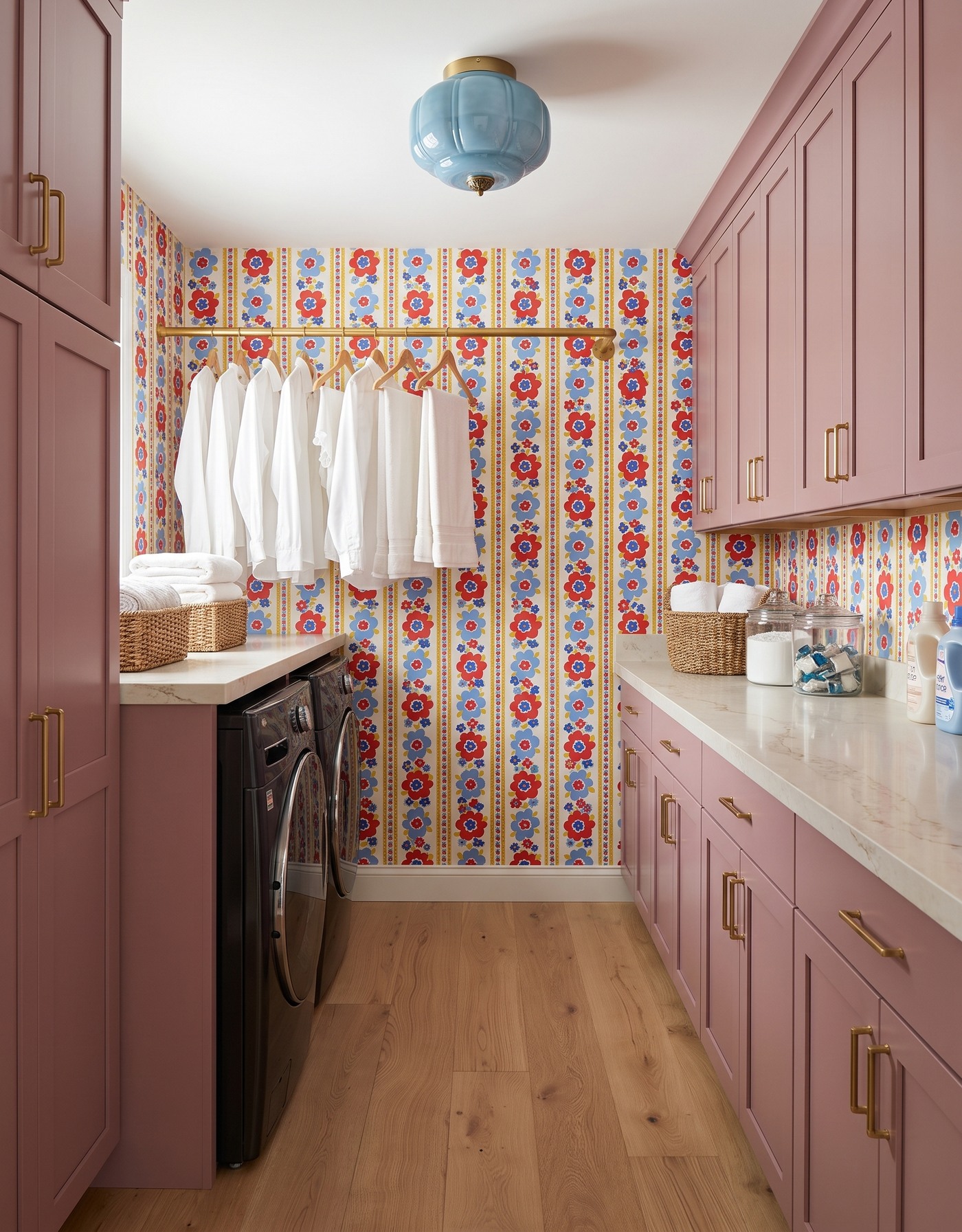 AI-created concept: Mauve laundry cabinets, red-and-blue floral stripes, a pale-blue light and black machines along the left wall.