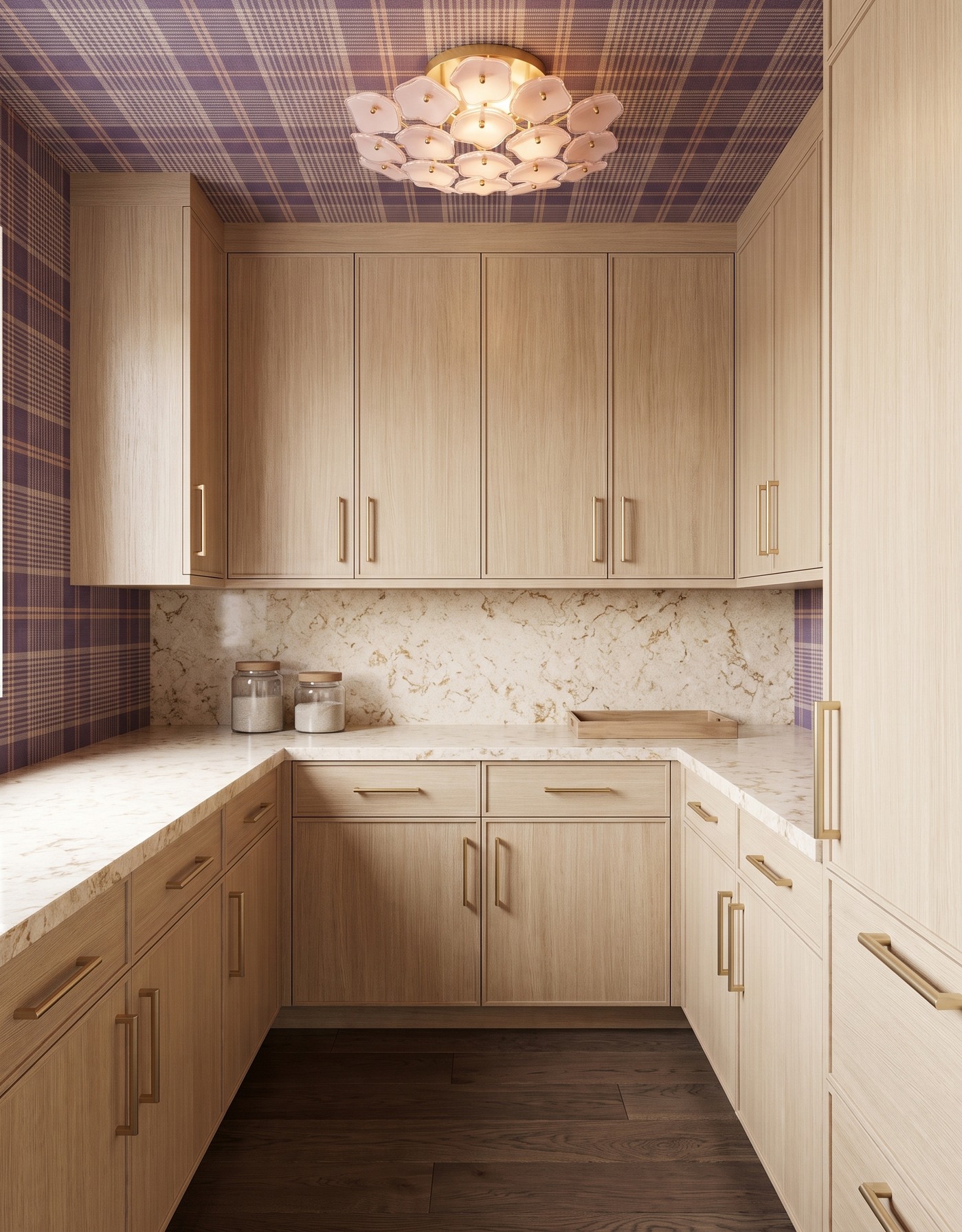 Pantry with pale wood cabinets, plum-and-ochre plaid wallpaper, cream gold-veined counter, dark wood floor and blush floral light.