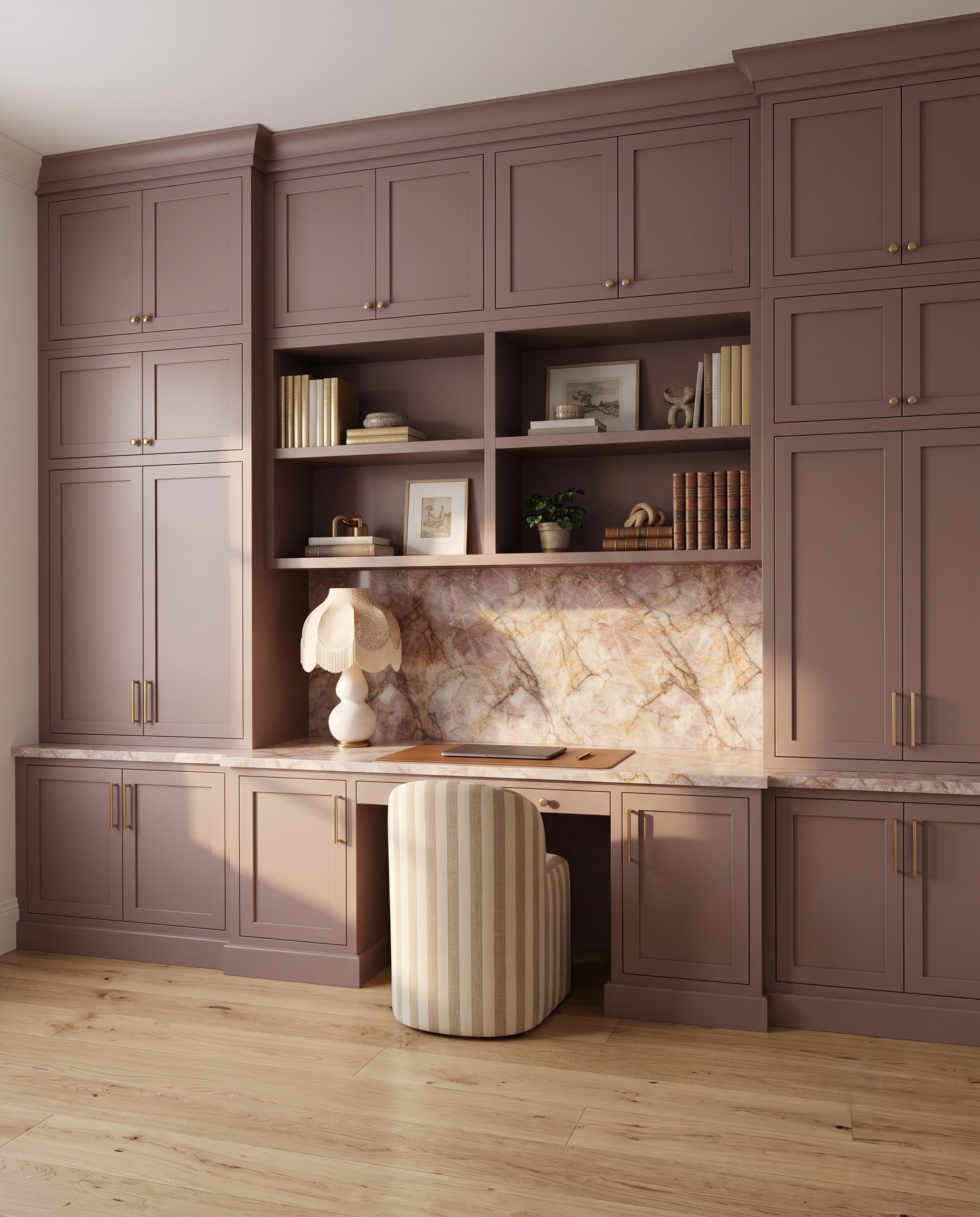 Dusty-plum built-in desk with drawers, upper storage, and a marble-look work panel.