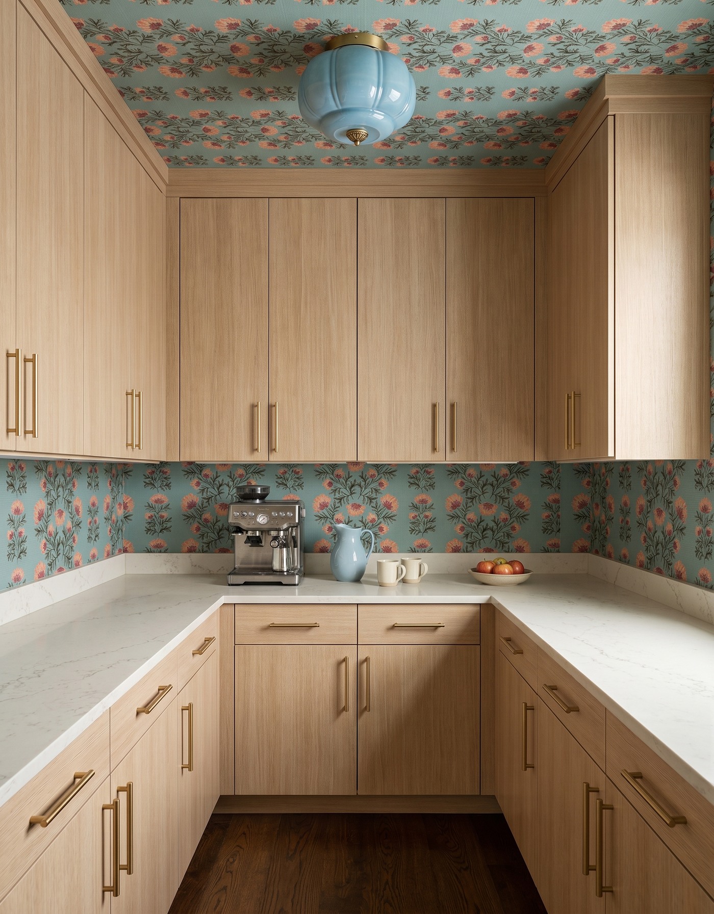 AI-created concept: Pale-oak-toned pantry cabinets surround aqua-and-coral floral wallpaper and a blue light.