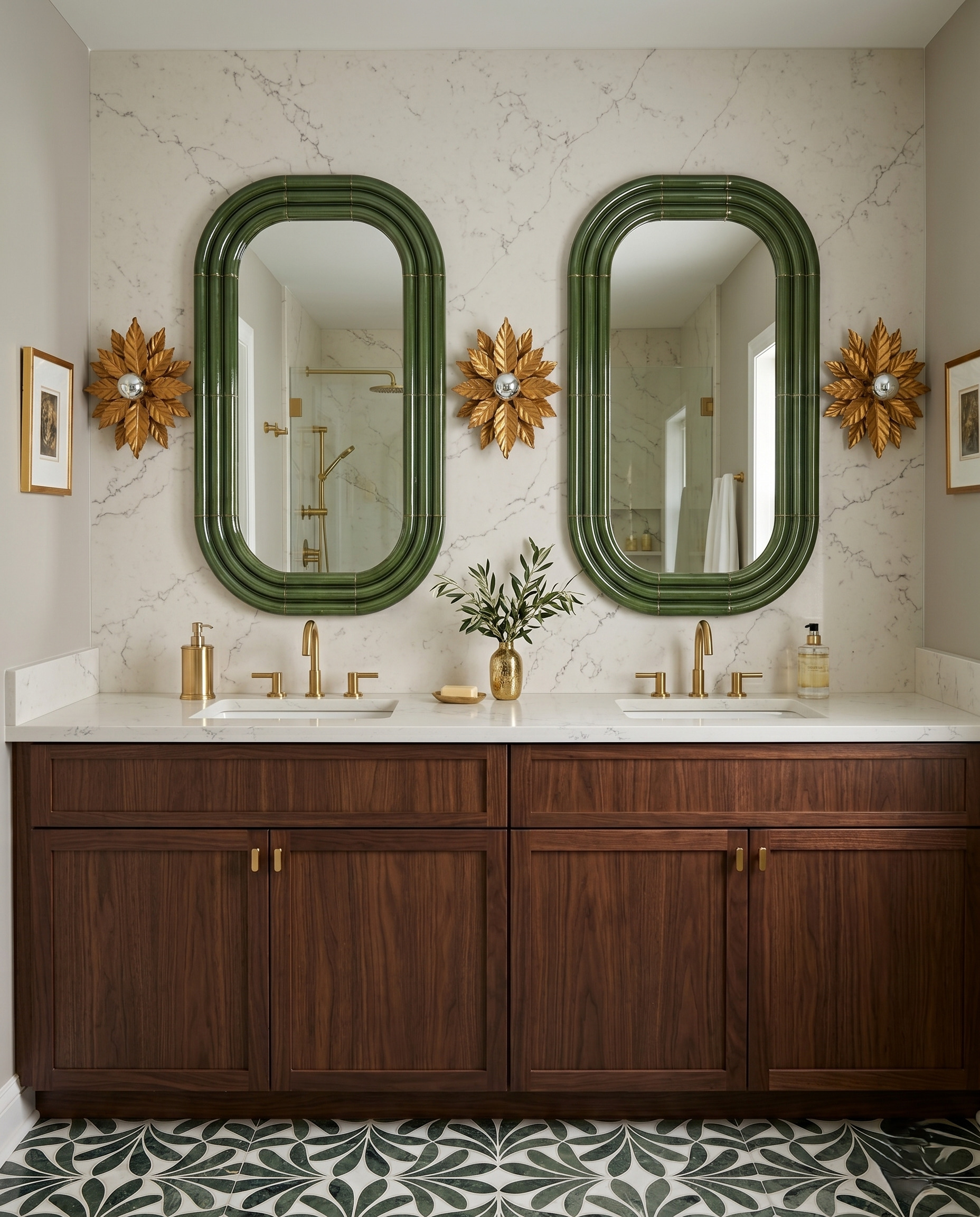 Wood double vanity with dark green rounded mirror frames, gold floral sconces, pale veined walls and a green-and-white leaf-pattern floor.