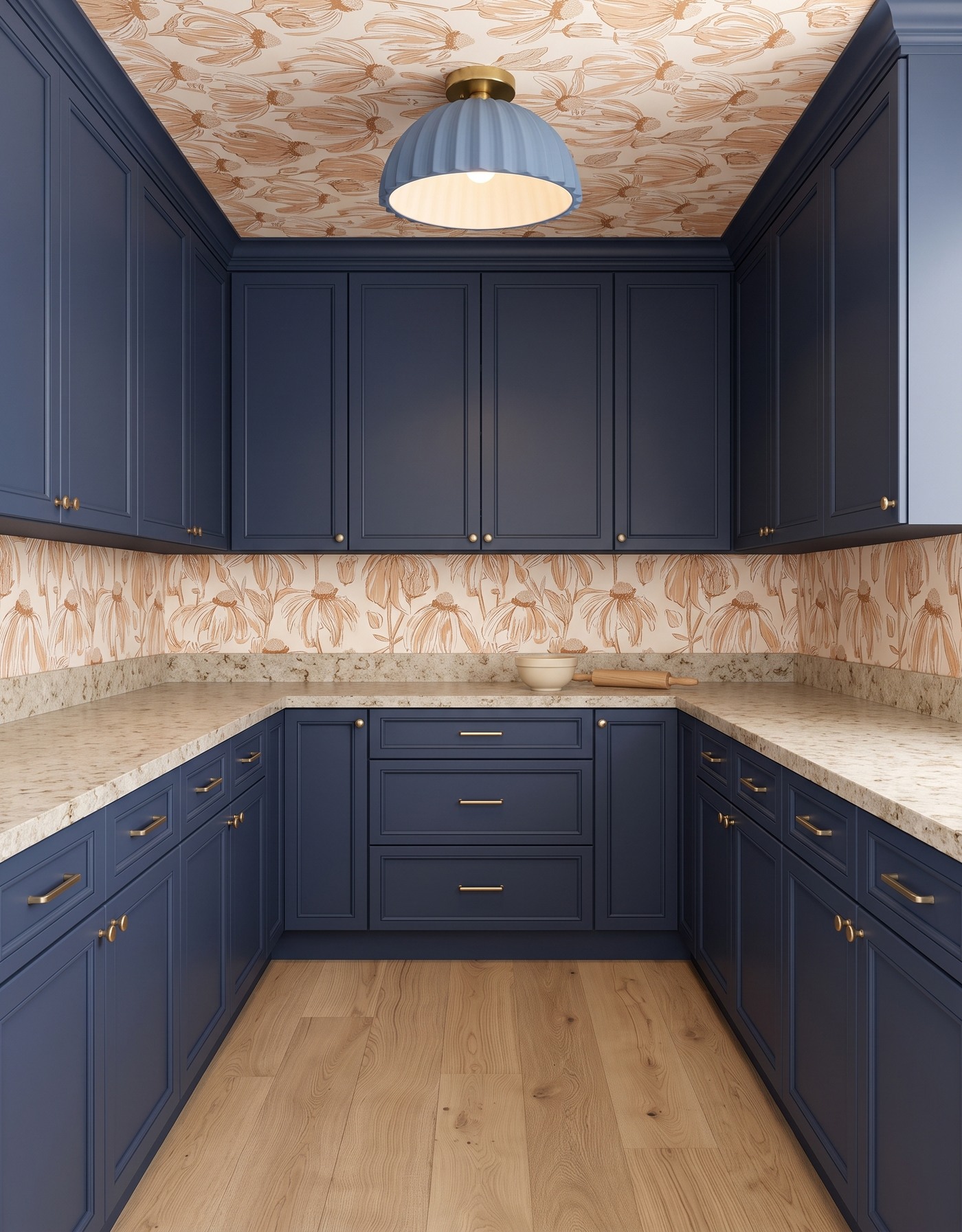 Pantry with deep blue cabinets, ivory-and-ochre line-drawn floral wallpaper, warm mottled cream counter, pale wood floor and blue ribbed light.