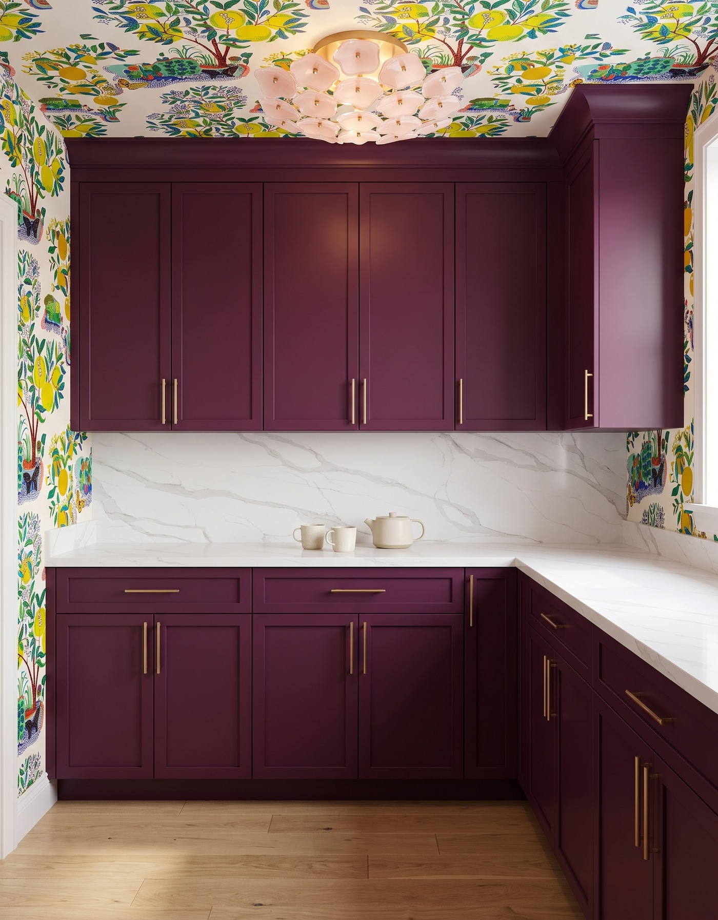 Pantry with burgundy cabinets, multicolor lemon-tree wallpaper, white diagonal gray-veined counters, honey wood floor and blush flower light.