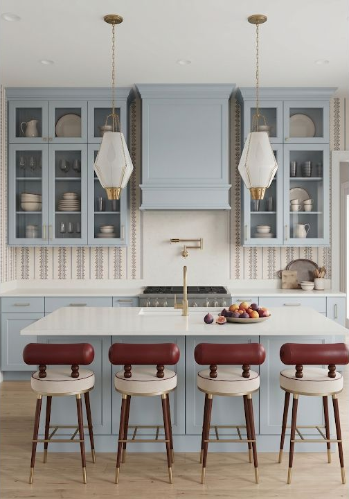 Concept image of a pale blue kitchen with tall glass-front cabinets, a light ceiling, pendant fixtures, and island stools.